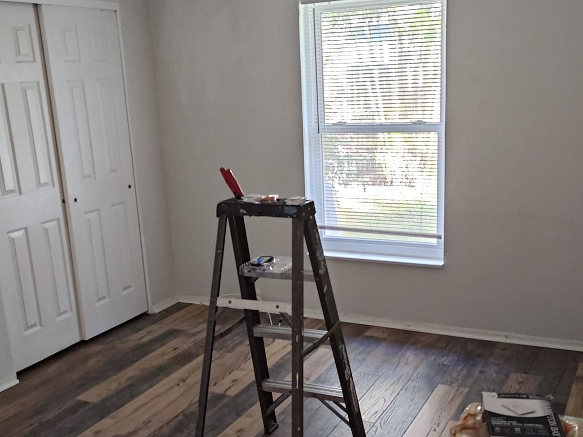 Bedroom with new wood-look plank flooring and fresh gray paint