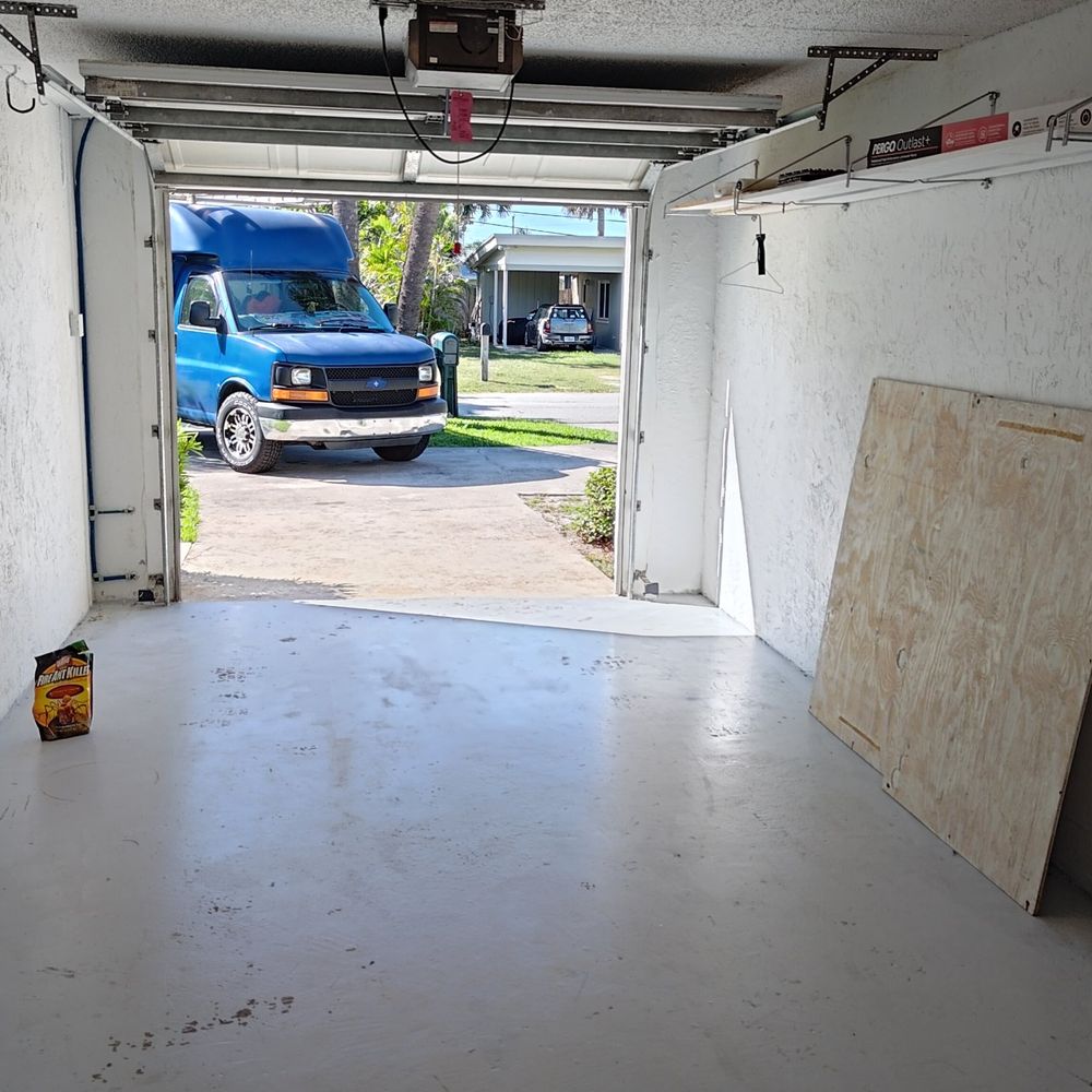 The same garage emptied, with freshly painted walls and floor