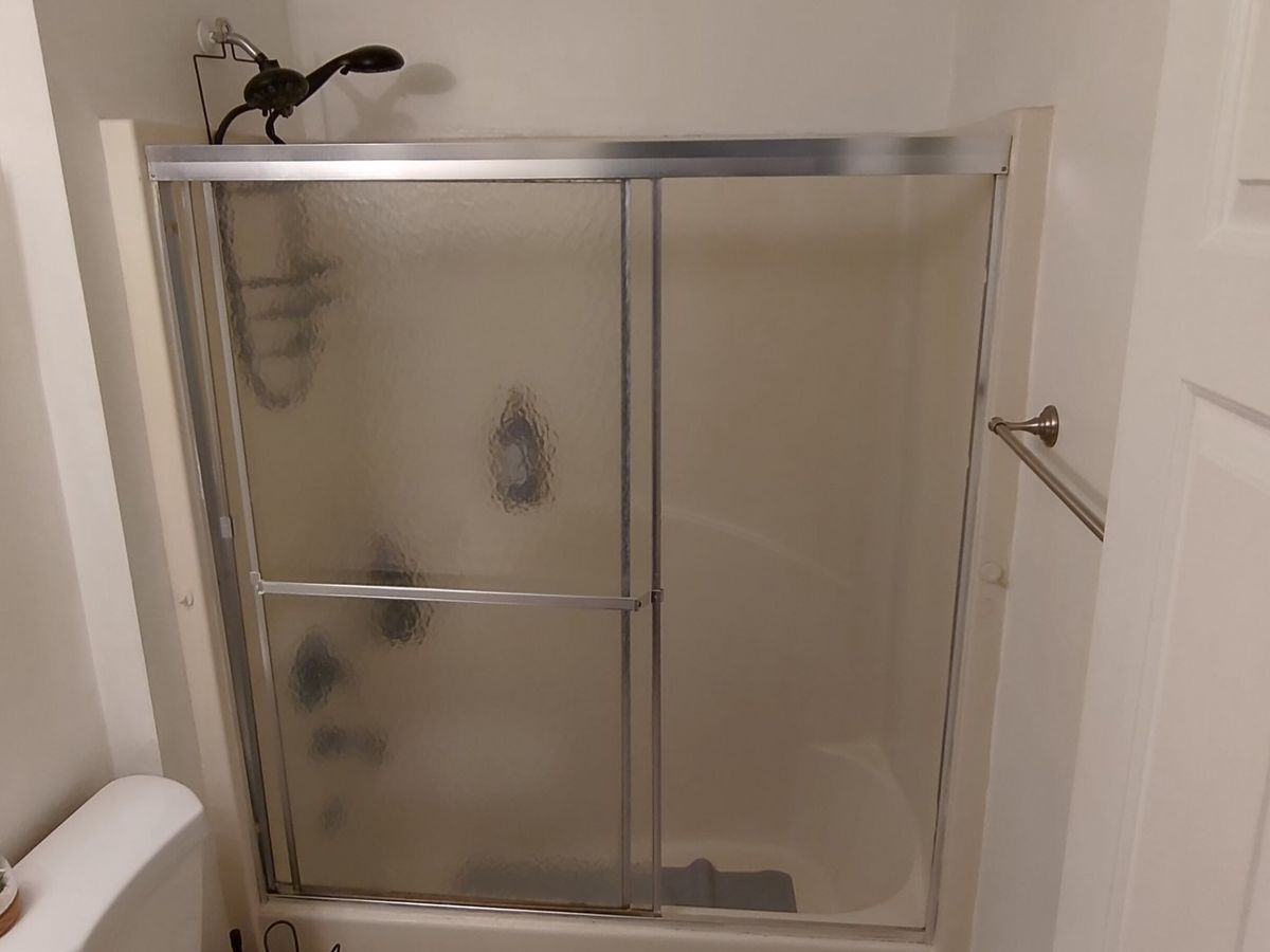 Sliding glass shower doors installed on a tub surround